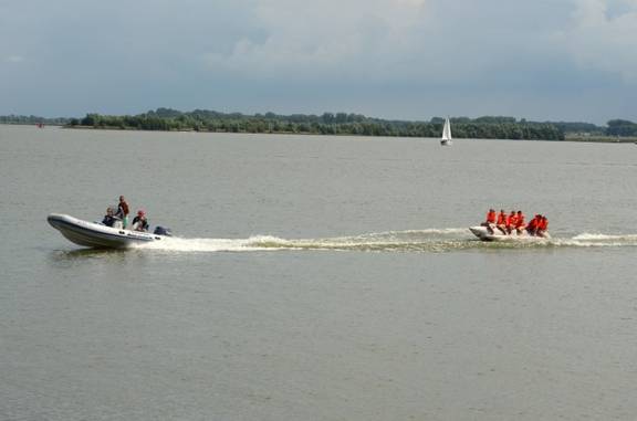 Festrumpfschlauchboot der Summertime zieht Gäste auf einem Schwimmreifen über das Wasser