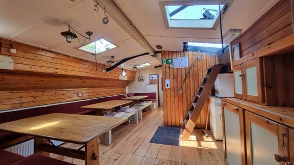 Blick in den Salon der Medusa mit Holztischen und Oberlichtern